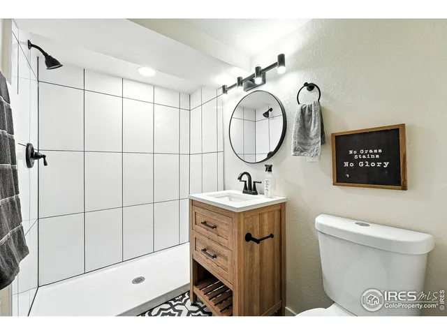 a bathroom with a toilet a sink and a mirror