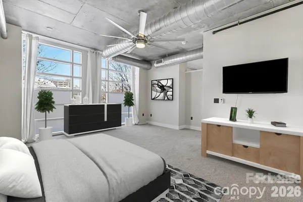 a bedroom with a bed and a flat screen tv