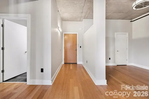a view of a hallway with wooden floor