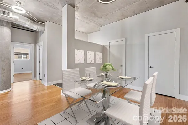a dining room with furniture and wooden floor