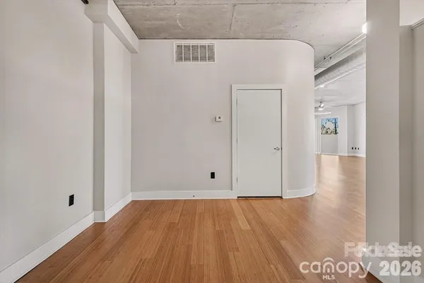 a view of a room with wooden floor