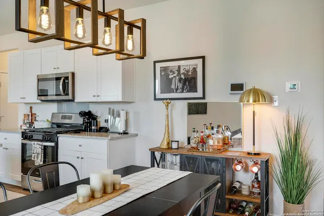 a kitchen with stainless steel appliances granite countertop a stove and cabinets