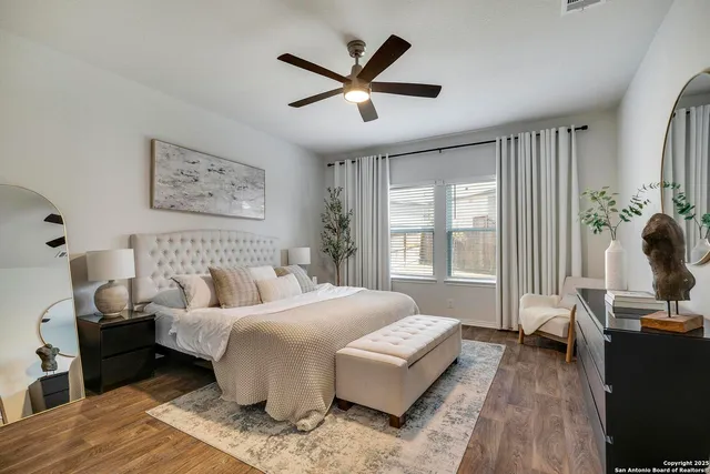 a bedroom with a bed and wooden floor