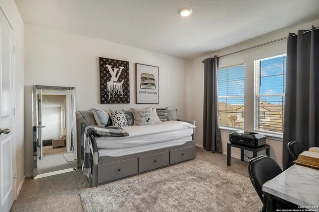 a spacious bedroom with a bed and a window