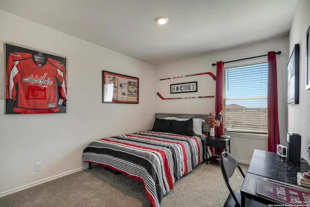 a bedroom with a bed and chair