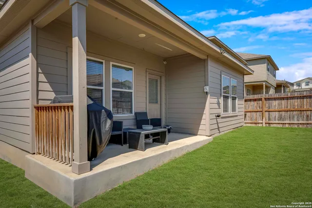 a view of a house with backyard and porch