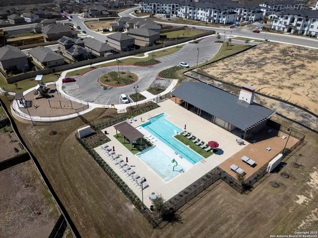 an aerial view of a house with pool table and chairs