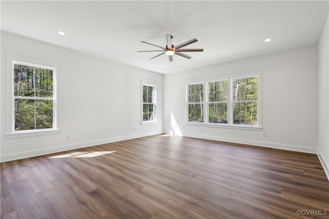 4750 Studley Road Mechanicsville, VA 23116 - Photo 19 of 36 an empty room with wooden floor ceiling fan and windows