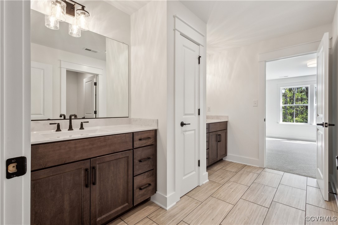 4750 Studley Road Mechanicsville, VA 23116 - Photo 24 of 36 a spacious bathroom with a double vanity sink a large mirror and a bathtub