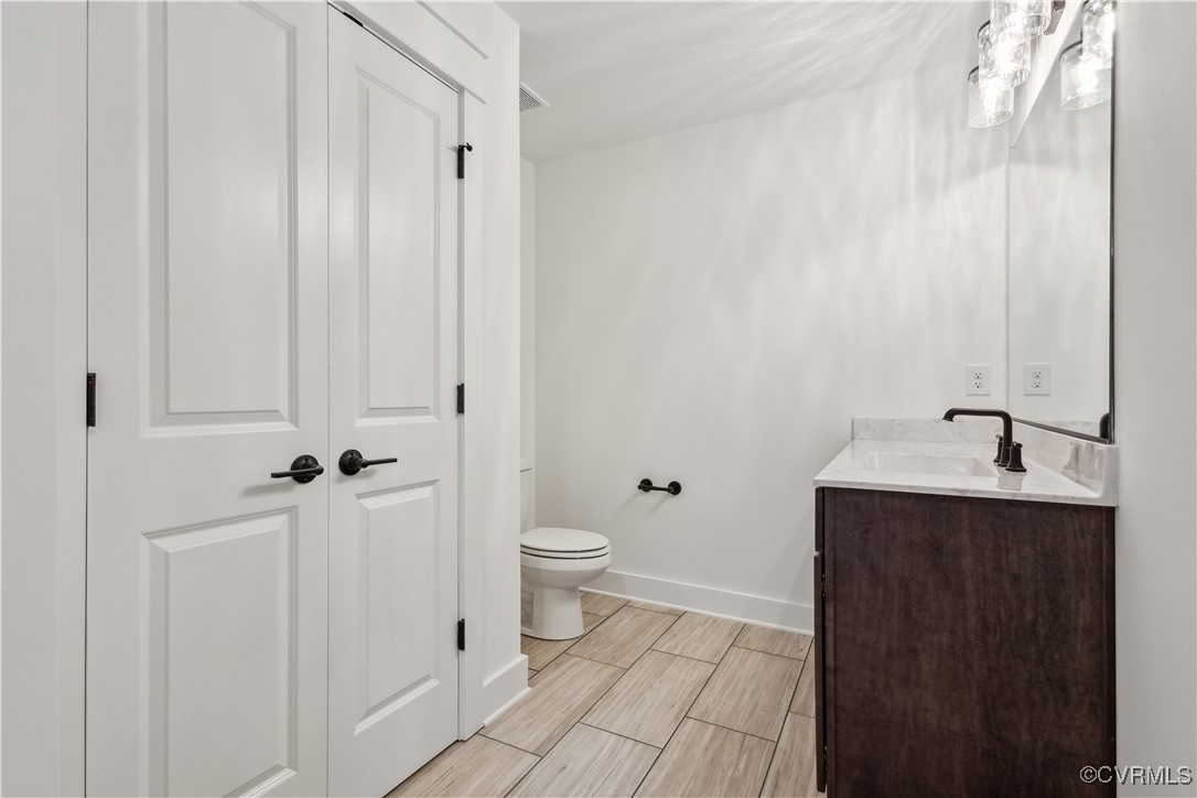 4750 Studley Road Mechanicsville, VA 23116 - Photo 31 of 36 a bathroom with a toilet a sink and mirror