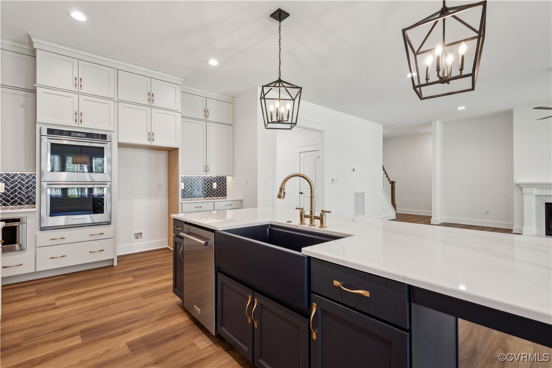 4750 Studley Road Mechanicsville, VA 23116 - Photo 7 of 36 a kitchen with stainless steel appliances granite countertop a sink a stove and a wooden floors