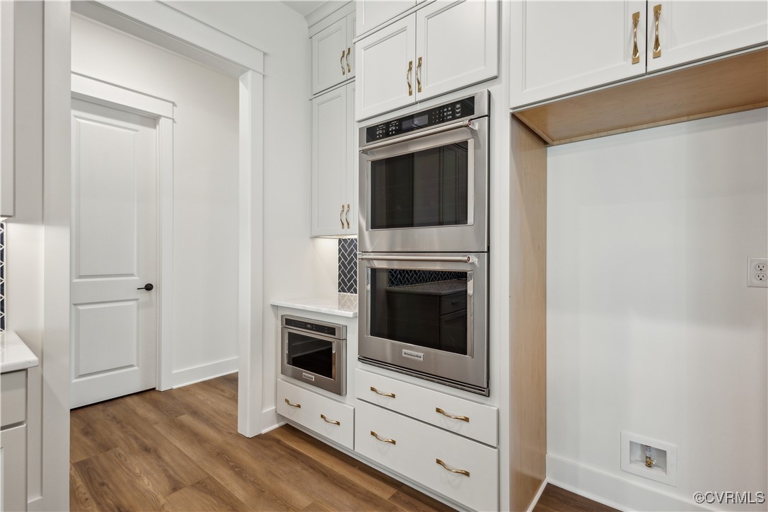 4750 Studley Road Mechanicsville, VA 23116 - Photo 8 of 36 a kitchen with granite countertop white cabinets and stainless steel appliances