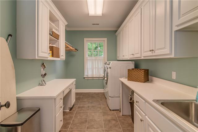 129 Alton Road Nashville, TN 37205 - Photo 17 of 20 a utility room with a sink a washer and dryer