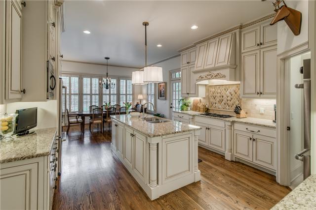 129 Alton Road Nashville, TN 37205 - Photo 7 of 20 a kitchen with stainless steel appliances granite countertop a stove oven a refrigerator a sink and white cabinets with wooden floor