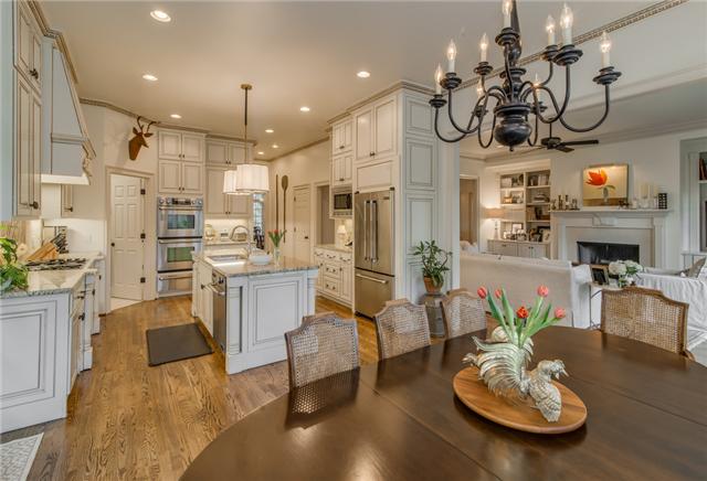 129 Alton Road Nashville, TN 37205 - Photo 8 of 20 a kitchen with stainless steel appliances kitchen island granite countertop a stove and white cabinets