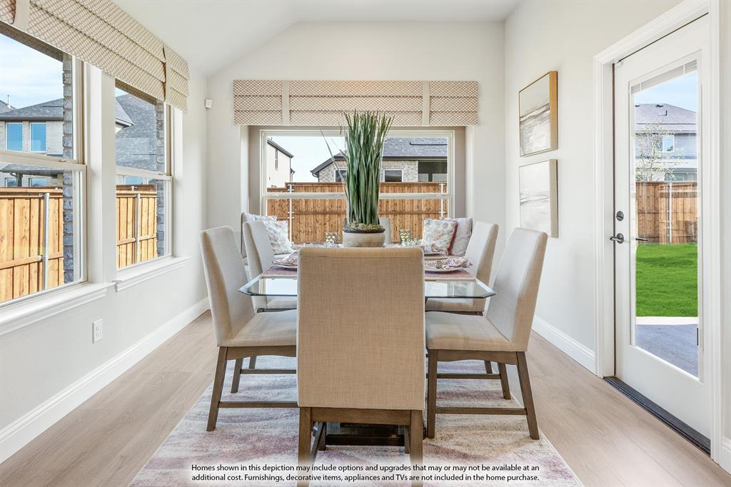 5930 Merian Drive Pilot Point, TX 76258 - Photo 16 of 39 a dining room with furniture a rug and wooden floor