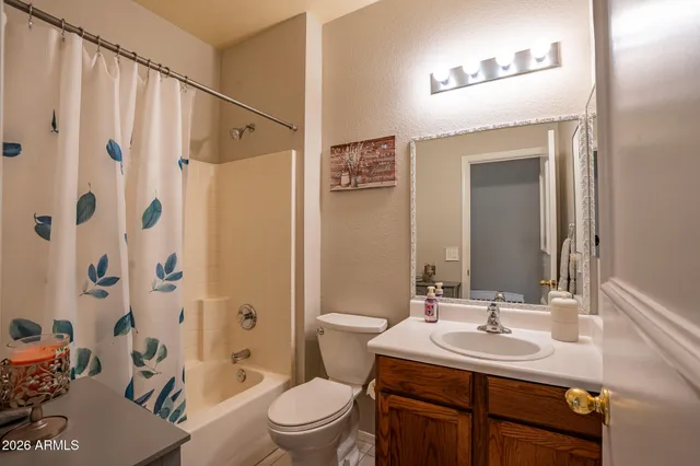 a bathroom with a sink toilet double vanity and shower