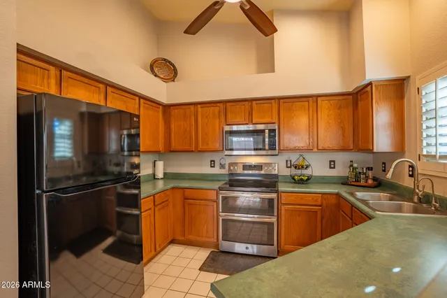 a kitchen with granite countertop a sink stainless steel appliances and cabinets
