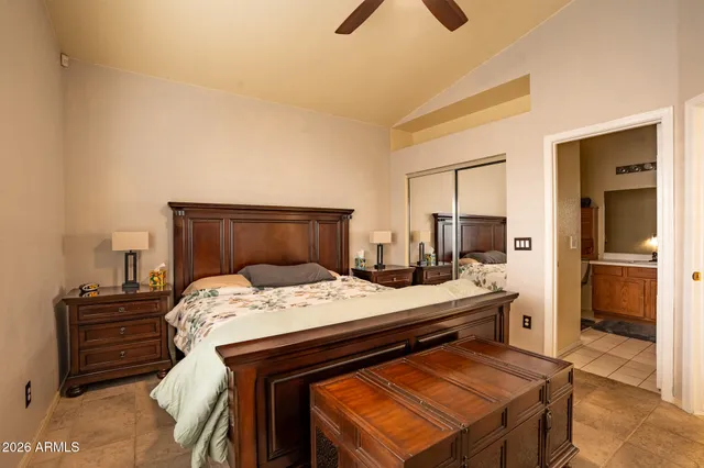 a bedroom with a bed and two windows