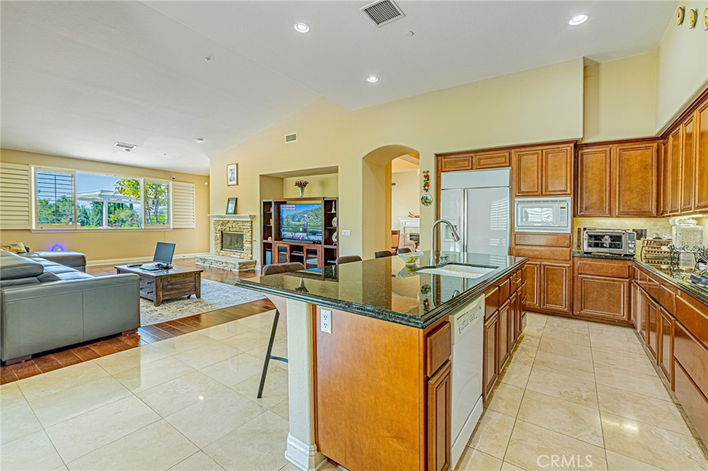 4088 Shady Ridge Circle Corona, CA 92881 - Photo 34 of 47 a kitchen with stainless steel appliances granite countertop a sink and cabinets