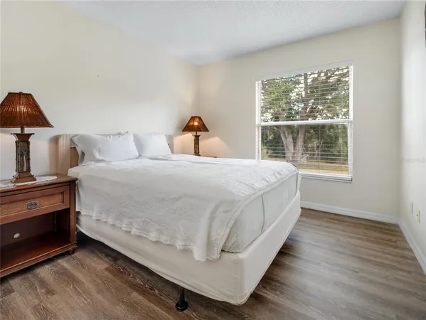 a bedroom with two beds and a large window