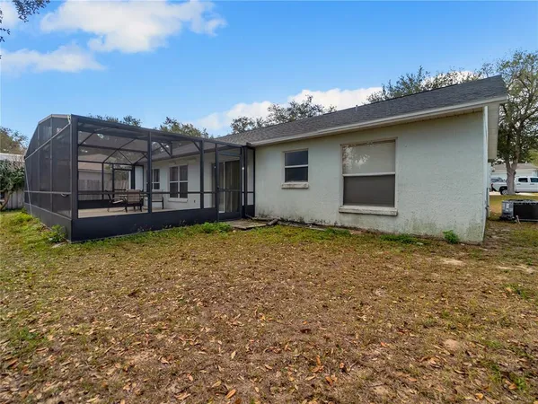a view of hallway with furniture and a refrigerator