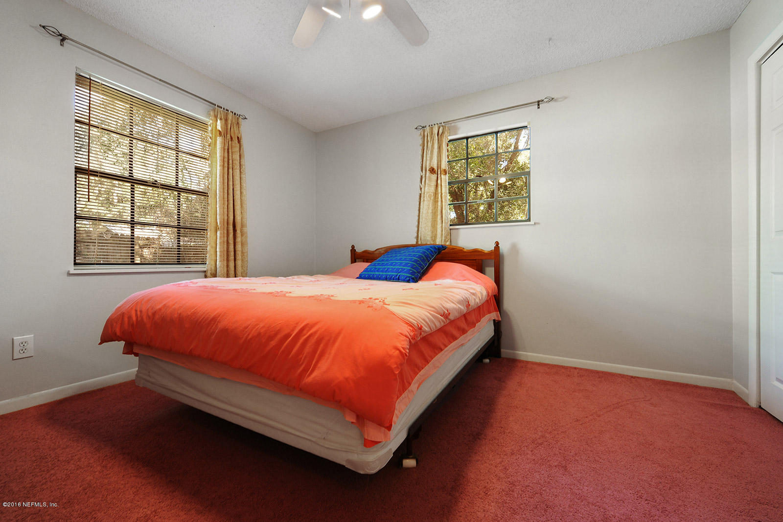 161 Drake Road St. Augustine, FL 32086 - Photo 12 of 15 a bed sitting in a bedroom next to a window