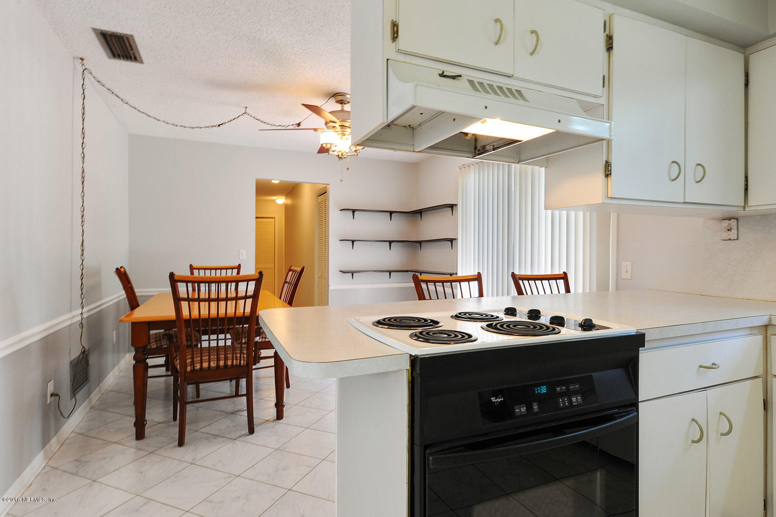 161 Drake Road St. Augustine, FL 32086 - Photo 8 of 15 a kitchen with a table chairs stove and cabinets