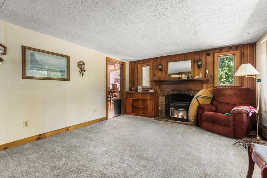 627 First Parish Road Scituate, MA 02066 - Photo 14 of 33 a living room with furniture and a fireplace