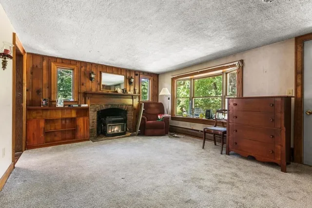 a view of a livingroom with furniture and a fireplace