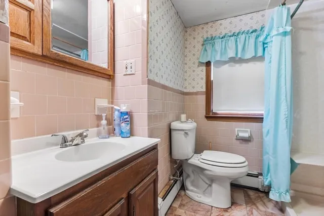 a bathroom with a sink toilet and mirror
