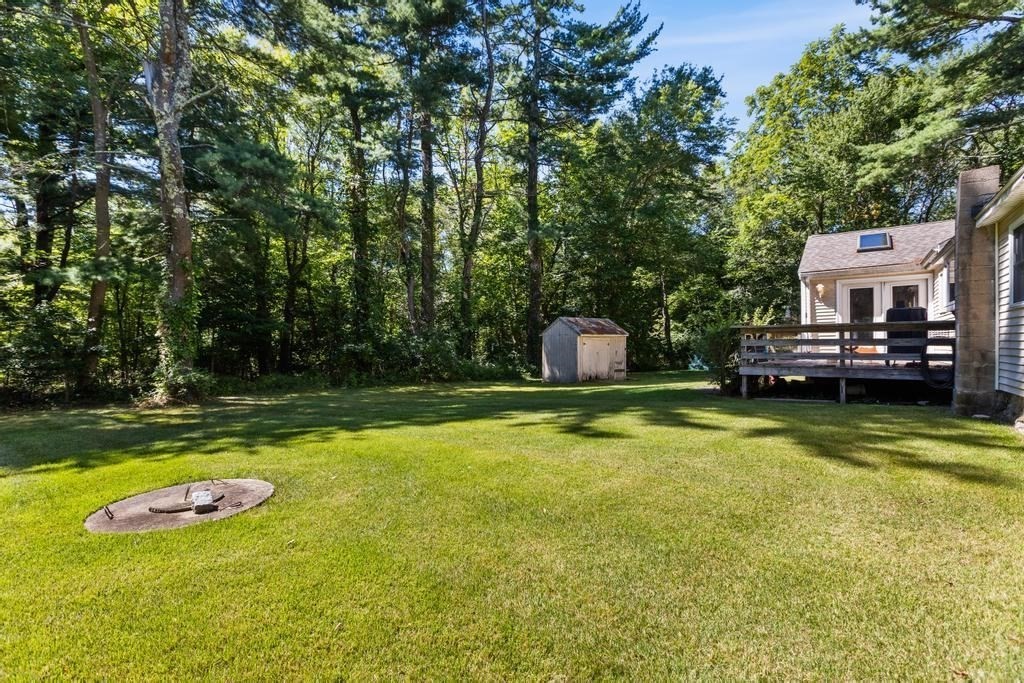 627 First Parish Road Scituate, MA 02066 - Photo 3 of 33 a view of a swimming pool with a yard and large trees
