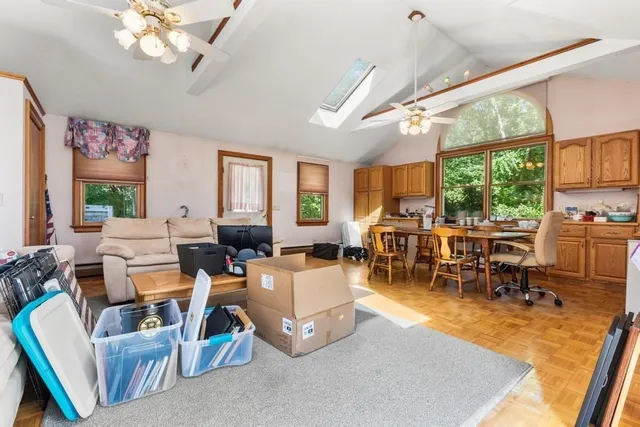 a living room with lots of furniture and a large window