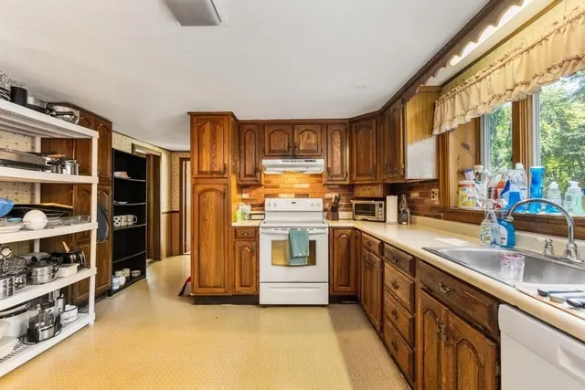 a kitchen with stainless steel appliances a stove a sink and a refrigerator