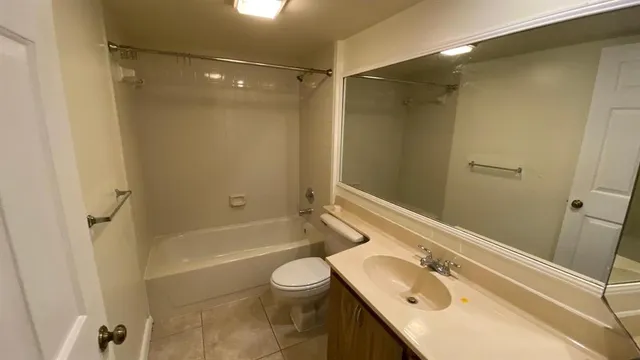 a bathroom with a sink toilet tub and shower