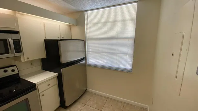 a utility room with cabinets washer and dryer