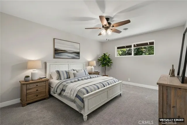 a bedroom with a large bed and a chandelier