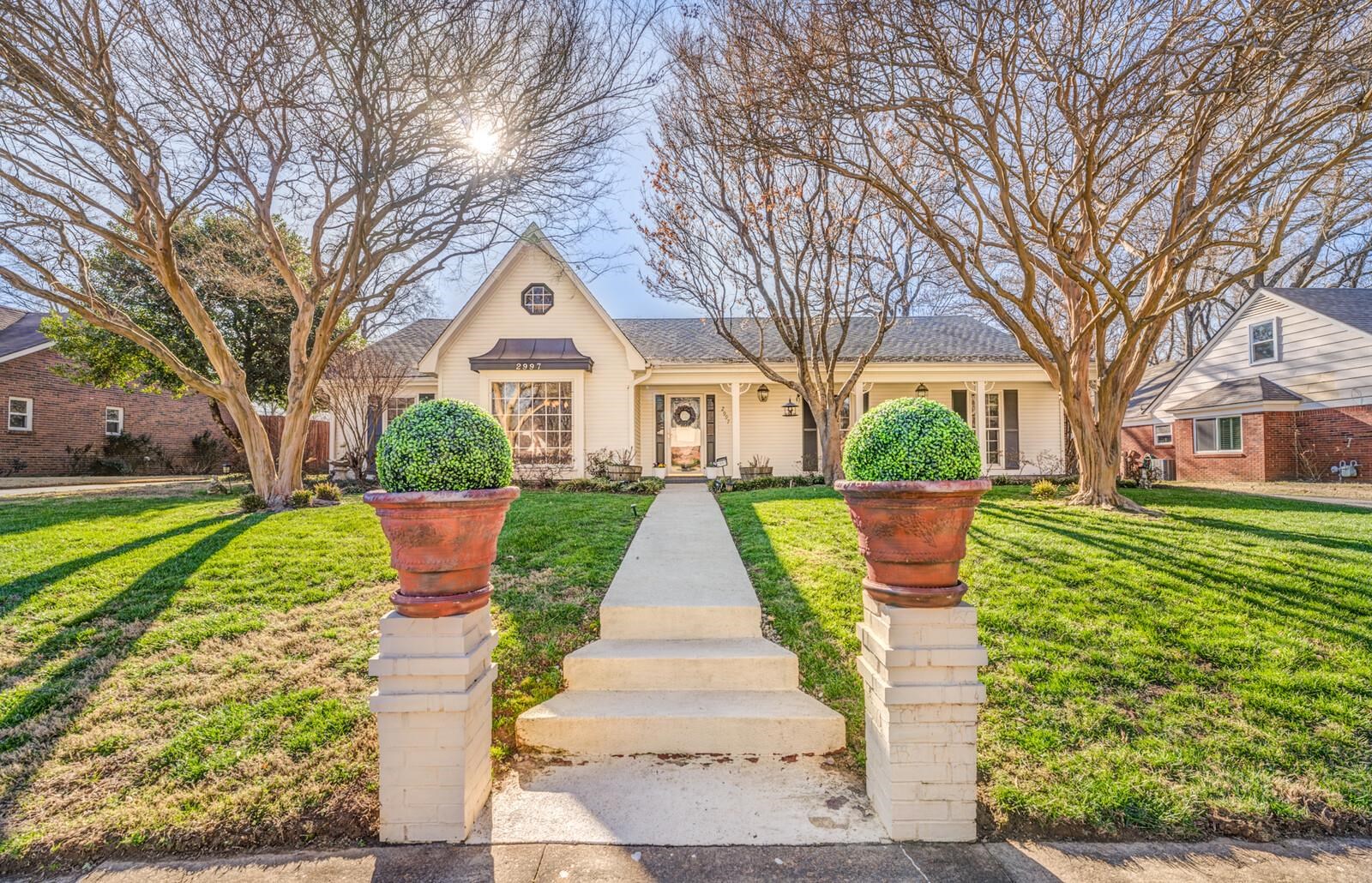 2997 Riverdale Road Memphis, TN 38119 - Photo 1 of 35 View of front of home featuring a front lawn, covered porch, and a shingled roof