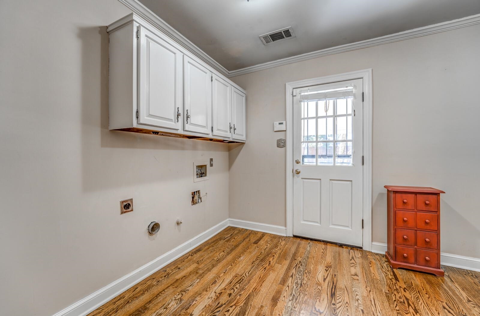 2997 Riverdale Road Memphis, TN 38119 - Photo 12 of 35 Laundry room with gas dryer hookup, cabinet space, washer hookup, light wood-type flooring, and crown molding