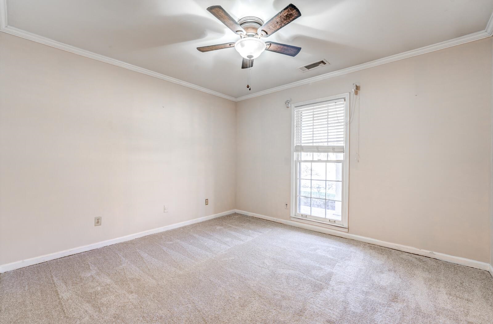 2997 Riverdale Road Memphis, TN 38119 - Photo 19 of 35 Unfurnished room with crown molding, light colored carpet, and a ceiling fan