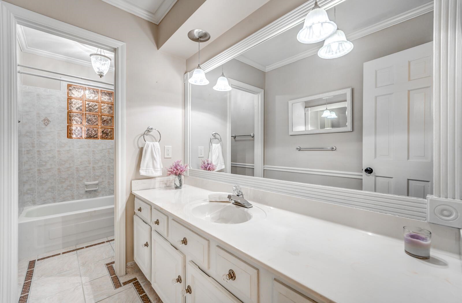 2997 Riverdale Road Memphis, TN 38119 - Photo 20 of 35 Full bath with vanity, crown molding, shower / bath combo, inlaid floor details, and light tile patterned flooring