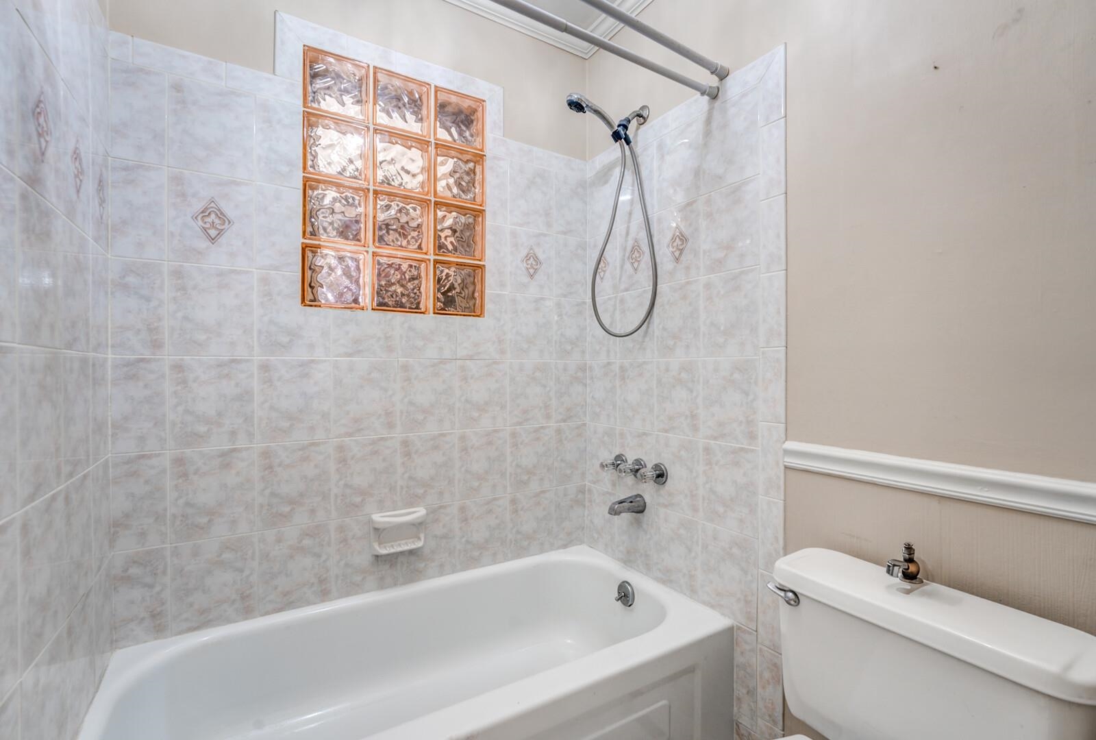 2997 Riverdale Road Memphis, TN 38119 - Photo 21 of 35 Full bathroom featuring bathtub / shower combination and a wainscoted wall