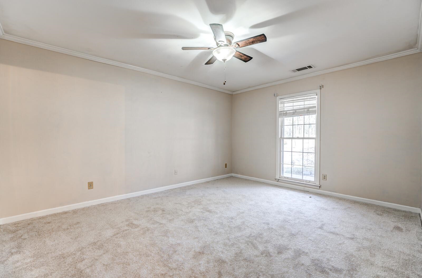 2997 Riverdale Road Memphis, TN 38119 - Photo 22 of 35 Empty room featuring crown molding, light carpet, and ceiling fan
