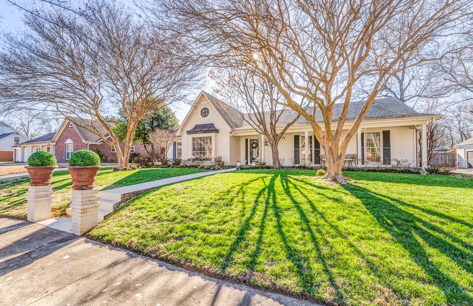 2997 Riverdale Road Memphis, TN 38119 - Photo 3 of 35 View of front of house with a front yard, covered porch, and a shingled roof
