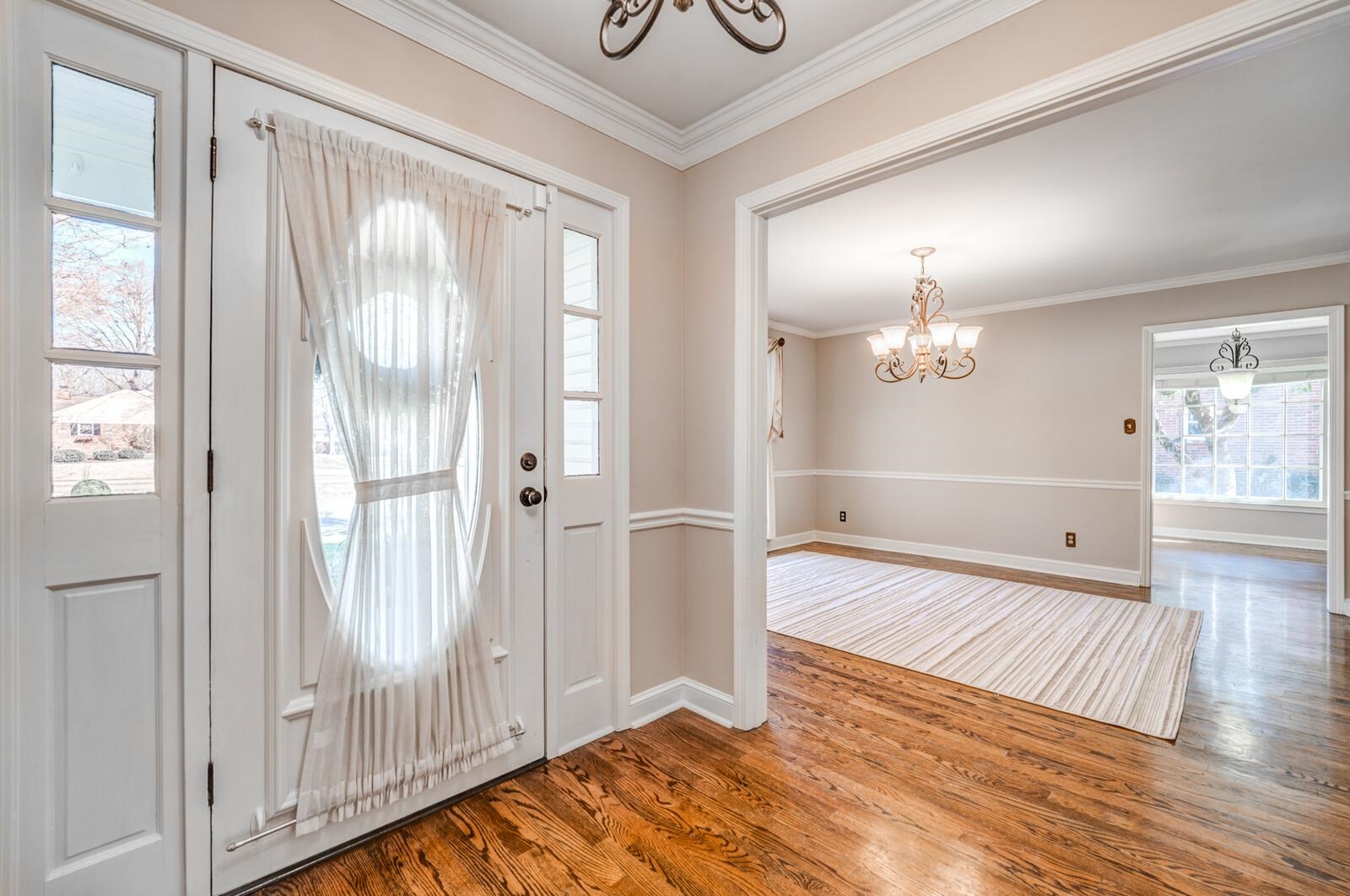 2997 Riverdale Road Memphis, TN 38119 - Photo 6 of 35 Foyer featuring hanging lights, ornamental molding, and wood finished floors