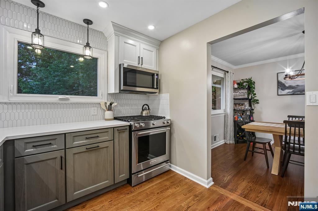 23 Andover Place Bloomfield, NJ 07003 - Photo 11 of 42 a kitchen with stainless steel appliances granite countertop a stove a microwave and a refrigerator