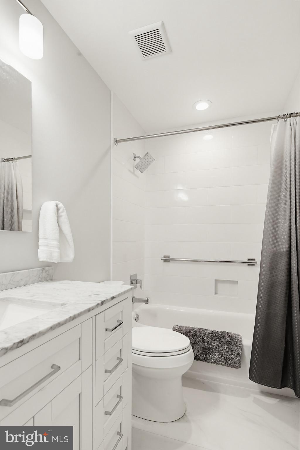 3067 Schubert Drive Silver Spring, MD 20904 - Photo 23 of 41 a bathroom with a granite countertop sink a toilet a mirror and shower