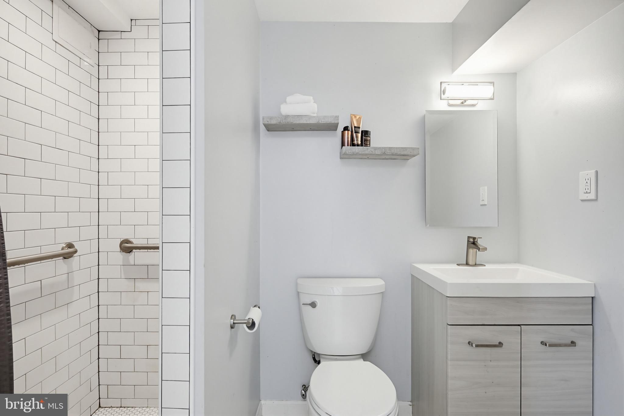 3067 Schubert Drive Silver Spring, MD 20904 - Photo 28 of 41 a bathroom with a toilet sink and mirror