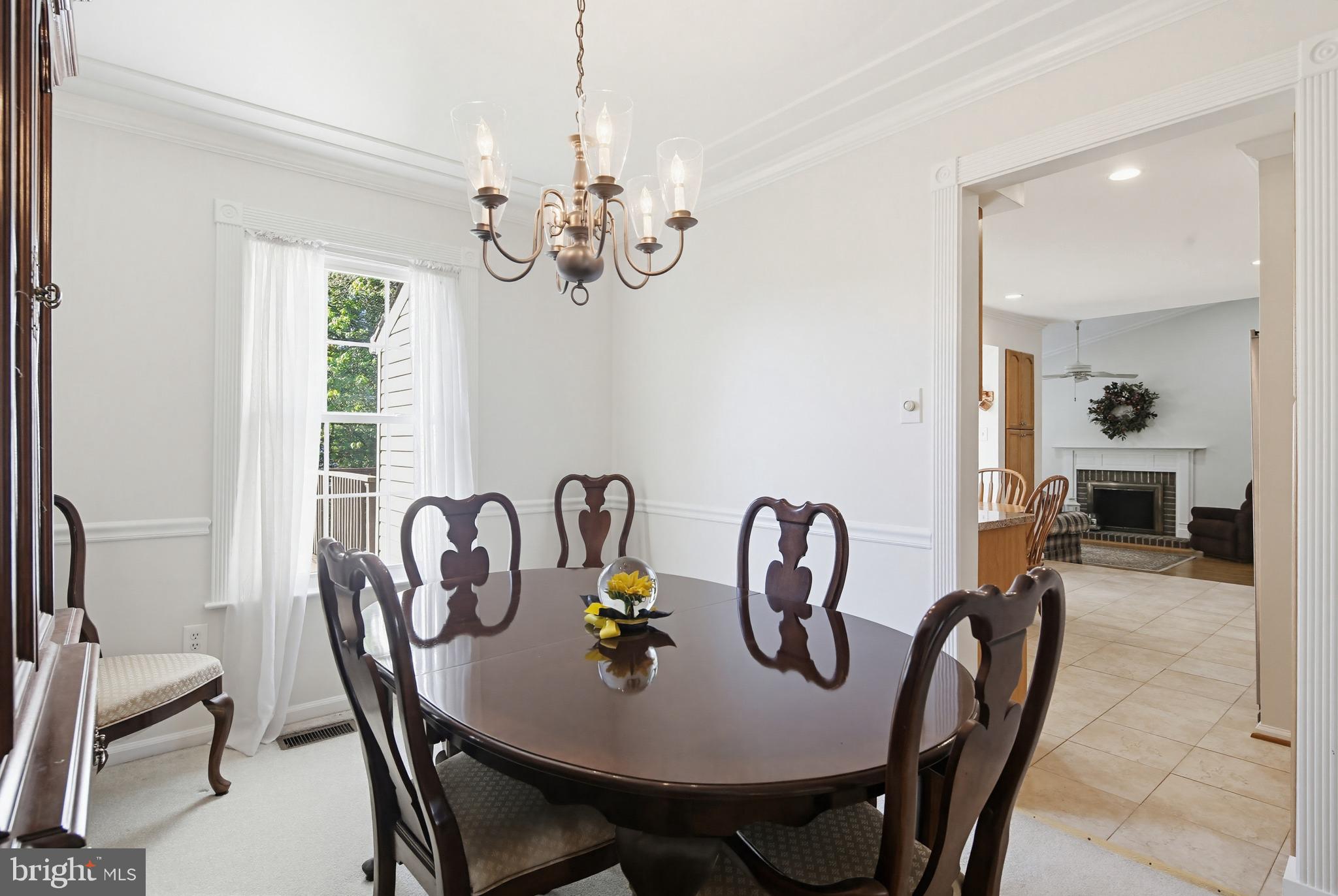 3067 Schubert Drive Silver Spring, MD 20904 - Photo 8 of 41 a dining room with furniture a chandelier and wooden floor