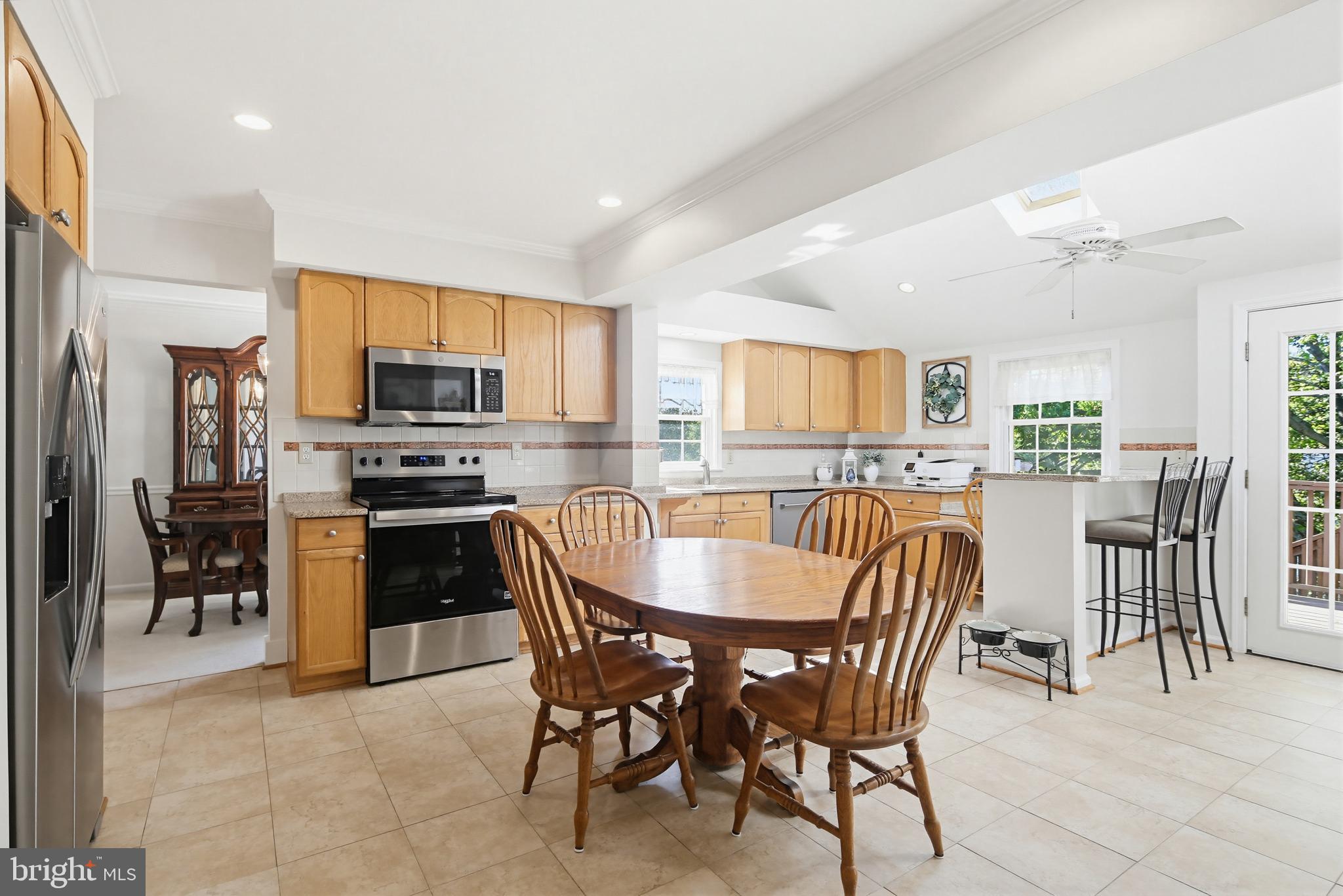 3067 Schubert Drive Silver Spring, MD 20904 - Photo 10 of 41 a dining area with stainless steel appliances a dining table chairs and refrigerator